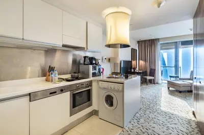 a kitchen with a washer and dryer in a room at Luxury Studio in Emaar Residence Fashion Avenue in Dubai
