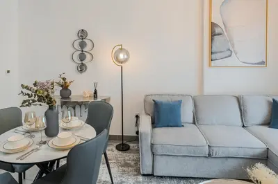 a living room with a couch and a table at Clever Guest 029 Bella Rose in Dubai