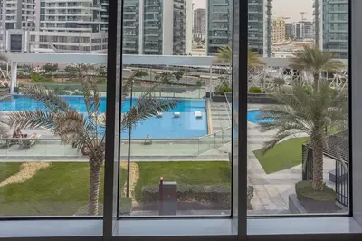 a view of a pool from a window at Clever Guest 029 Bella Rose in Dubai
