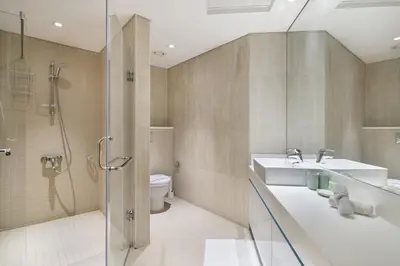 a bathroom with a shower and a sink and a toilet at Luxury 4BR Apartment in JBR Private Beach Access in Dubai