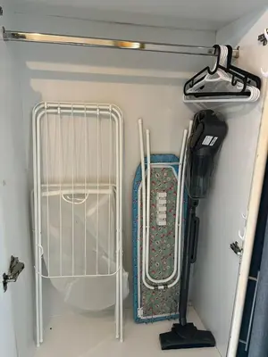 a small refrigerator with a rack in a room at MarinaBliss in Dubai