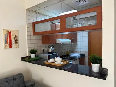 a kitchen with a sink and a counter top at MarinaBliss in Dubai