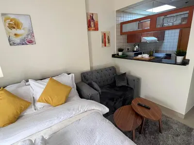 a living room with a couch and a table at MarinaBliss in Dubai