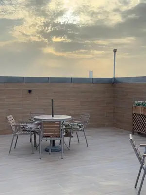 a table and chairs sitting on a patio at Spacious Studio in Dubai Sports City in Dubai