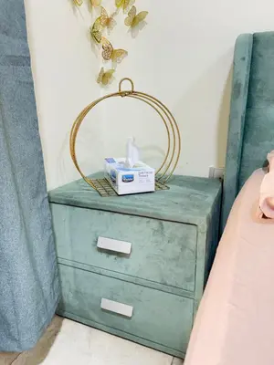 a green dresser with a mirror on it next to a bed at Spacious Studio in Dubai Sports City in Dubai