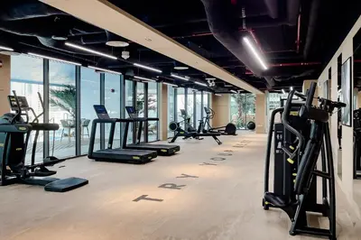 a gym with a bunch of treadmills and exercise bikes at Luxury Apartment in Business Bay in Dubai