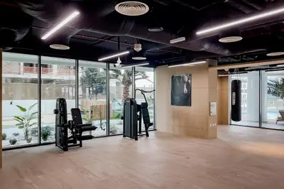 a gym with two treadmills and chairs and windows at Luxury Apartment in Business Bay in Dubai