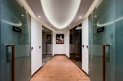 a hallway with glass doors and a wooden floor at Luxury Apartment in Business Bay in Dubai