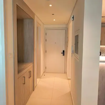 a hallway with a white door and a white tile floor at 7 palm Jumeirah one bedroom in Dubai