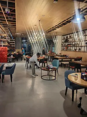 a man is working on a table in a restaurant at 7 palm Jumeirah one bedroom in Dubai