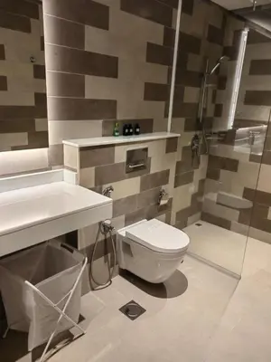 a bathroom with a toilet and a sink and a shower at 7 palm Jumeirah one bedroom in Dubai