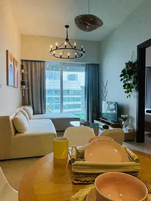 a living room with a couch and a table at Boho 2bhk near Dubai mall with best nightlife in Dubai
