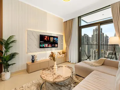 a living room with a couch and a table at Modern 1BR in DOWNTOWN I Near DUBAI MALL & FOUNTAIN in Dubai