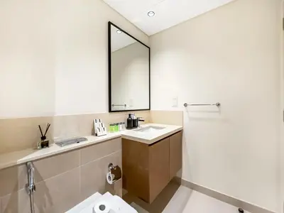 a bathroom with a sink and a mirror at Modern 1BR in DOWNTOWN I Near DUBAI MALL & FOUNTAIN in Dubai