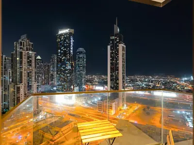 a view of a city skyline at night at Modern 1BR in DOWNTOWN I Near DUBAI MALL & FOUNTAIN in Dubai