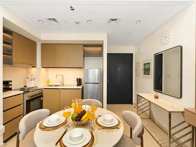 a kitchen and dining room with a table and chairs at Modern 1BR in DOWNTOWN I Near DUBAI MALL & FOUNTAIN in Dubai