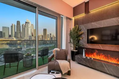 a living room with a large window with a view of the city at Gogoto2 Lux Burj Khalifa View 5 min Dubai Mall PS5 NYE Fireworks View in Dubai