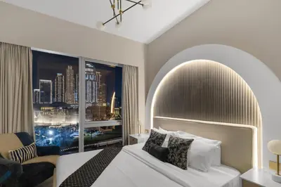 a bedroom with a bed and a large window at Gogoto2 Lux Burj Khalifa View 5 min Dubai Mall PS5 NYE Fireworks View in Dubai