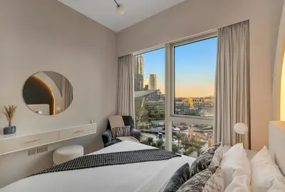 a bedroom with a bed and a large window at Gogoto2 Lux Burj Khalifa View 5 min Dubai Mall PS5 NYE Fireworks View in Dubai