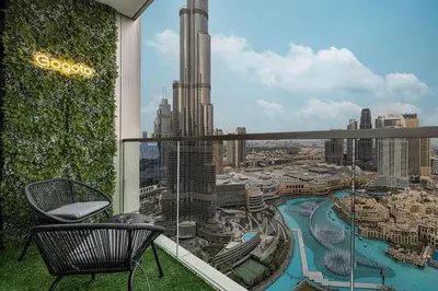 a chair on a balcony with a view of a city at Gogoto2 Lux Burj Khalifa View 5 min Dubai Mall PS5 NYE Fireworks View in Dubai