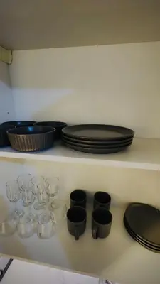 a shelf with glasses and plates on top at Azizi Rivieira Meydan, Dubai Luxury Studio with Burjkhalifa and Pool views in Dubai