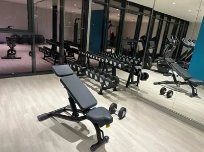 a gym with a row of chairs and mirrors at Azizi Rivieira Meydan, Dubai Luxury Studio with Burjkhalifa and Pool views in Dubai