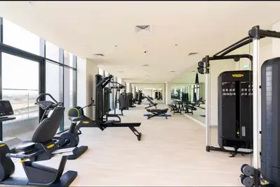 a gym with treadmills and elliptical machines at Azizi Rivieira Meydan, Dubai Luxury Studio with Burjkhalifa and Pool views in Dubai