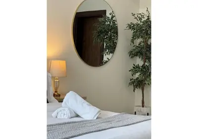 a bedroom with a bed with a mirror on the wall at Centrally Located in Business Bay - Huge 1 Bedroom Hall in Executive Towers in Dubai