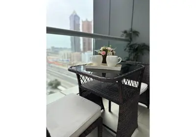 a balcony with a table with two mugs on it at Centrally Located in Business Bay - Huge 1 Bedroom Hall in Executive Towers in Dubai