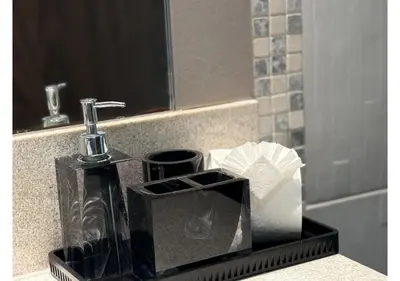 a bathroom sink with a soap dispenser and toilet paper at Centrally Located in Business Bay - Huge 1 Bedroom Hall in Executive Towers in Dubai