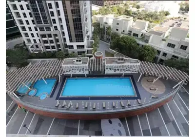 a swimming pool on top of a building with buildings at Centrally Located in Business Bay - Huge 1 Bedroom Hall in Executive Towers in Dubai