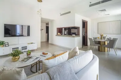 a living room with a couch and a table at Frank Porter - Beauport Tower in Dubai