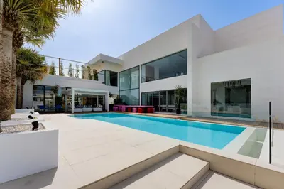 an exterior view of a house with a swimming pool at Resort Villa 19 in Dubai