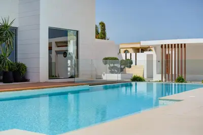 a swimming pool in front of a house at Resort Villa 19 in Dubai