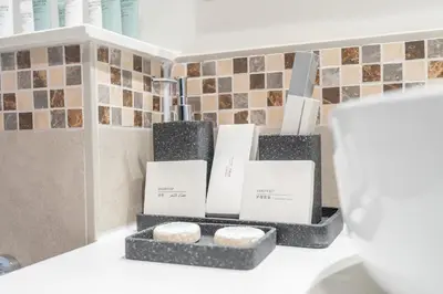 a group of three candles sitting on top of a counter at Burj View - Chic 2BR - 5min Dubai mall Canal in Dubai