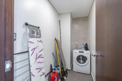 a small laundry room with a washing machine in it at Burj View - Chic 2BR - 5min Dubai mall Canal in Dubai