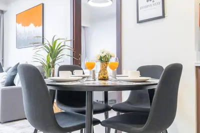 a dining room with a table and chairs at Burj View - Chic 2BR - 5min Dubai mall Canal in Dubai