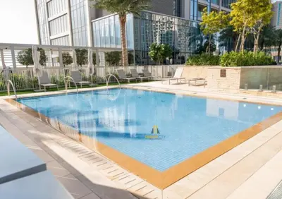 a large swimming pool in front of a building at Cozy & Modern 1 Bedroom Apartment in Downtown Dubai, Hosted by Desert City Stays in Dubai