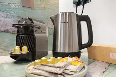 a coffee maker and a plate with some food at FIRST CLASS 4BR Burj Khalifa & Fountain View in Dubai