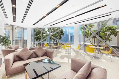 a living room with couches and tables and windows at FIRST CLASS 4BR Burj Khalifa & Fountain View in Dubai