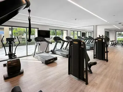a gym with a bunch of treadms and ellipticals at Walk to Dubai Mall- Enjoy Burj Khalifa Show in Dubai
