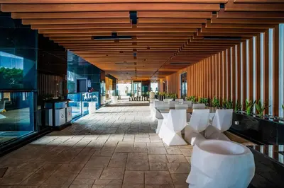 a hallway with white chairs and tables in a building at Stylish Studio Bayz Danube Burj Khalifa View Pool in Dubai