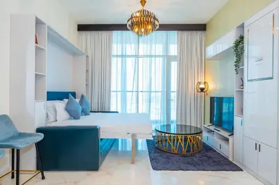 a bedroom with a bed and a large window at Stylish Studio Bayz Danube Burj Khalifa View Pool in Dubai