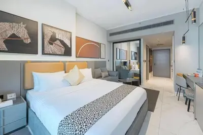 a bedroom with a large bed and a living room at CAICAI Homes Mag 318 Dubai Walking Distance to Dubai Mall in Dubai
