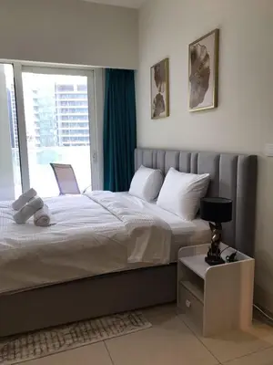 a bedroom with a large bed and a window at 2 bhk 3 mins in down town in Dubai