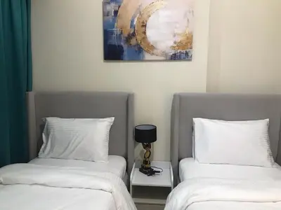 two beds sitting next to each other in a room at 2 bhk 3 mins in down town in Dubai