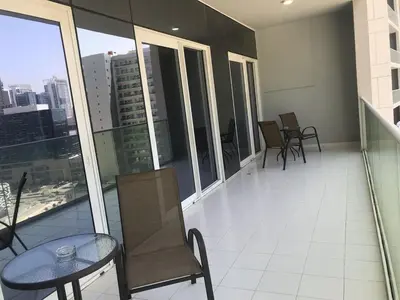 a balcony with a table and chairs on a building at 2 bhk 3 mins in down town in Dubai