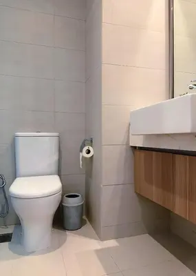 a bathroom with a toilet and a sink at Roomook Apartments in Dubai