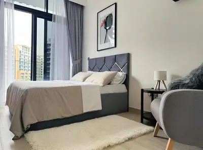 a bedroom with a bed and a large window at Roomook Apartments in Dubai