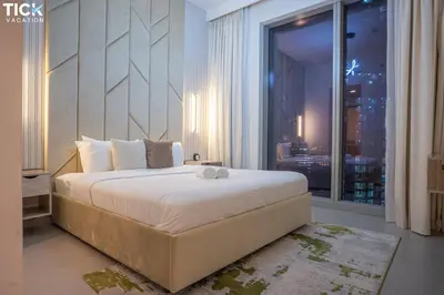 a bedroom with a large bed and a large window at 2BR Luxury Apartment Forte 2 Downtown 14th Floor in Dubai